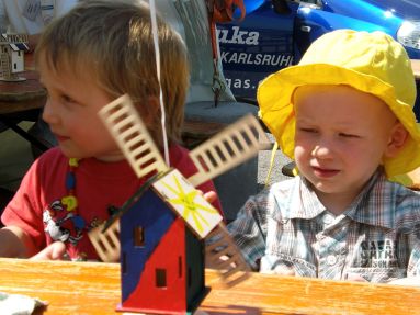 Zwei kleine Kinder vor Modell-Windmühle